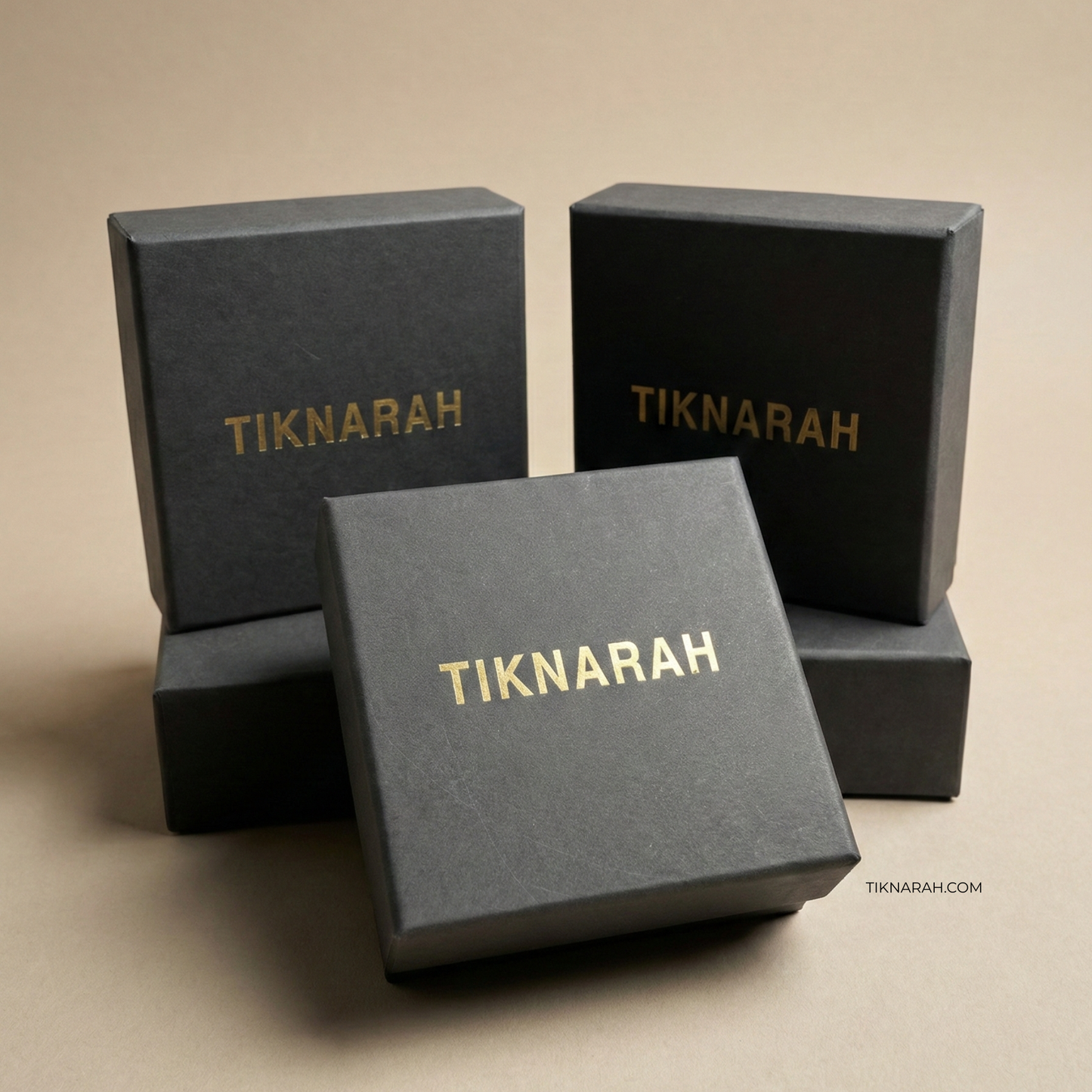 Black boxes with 'TIKNARAH' branding on a beige background