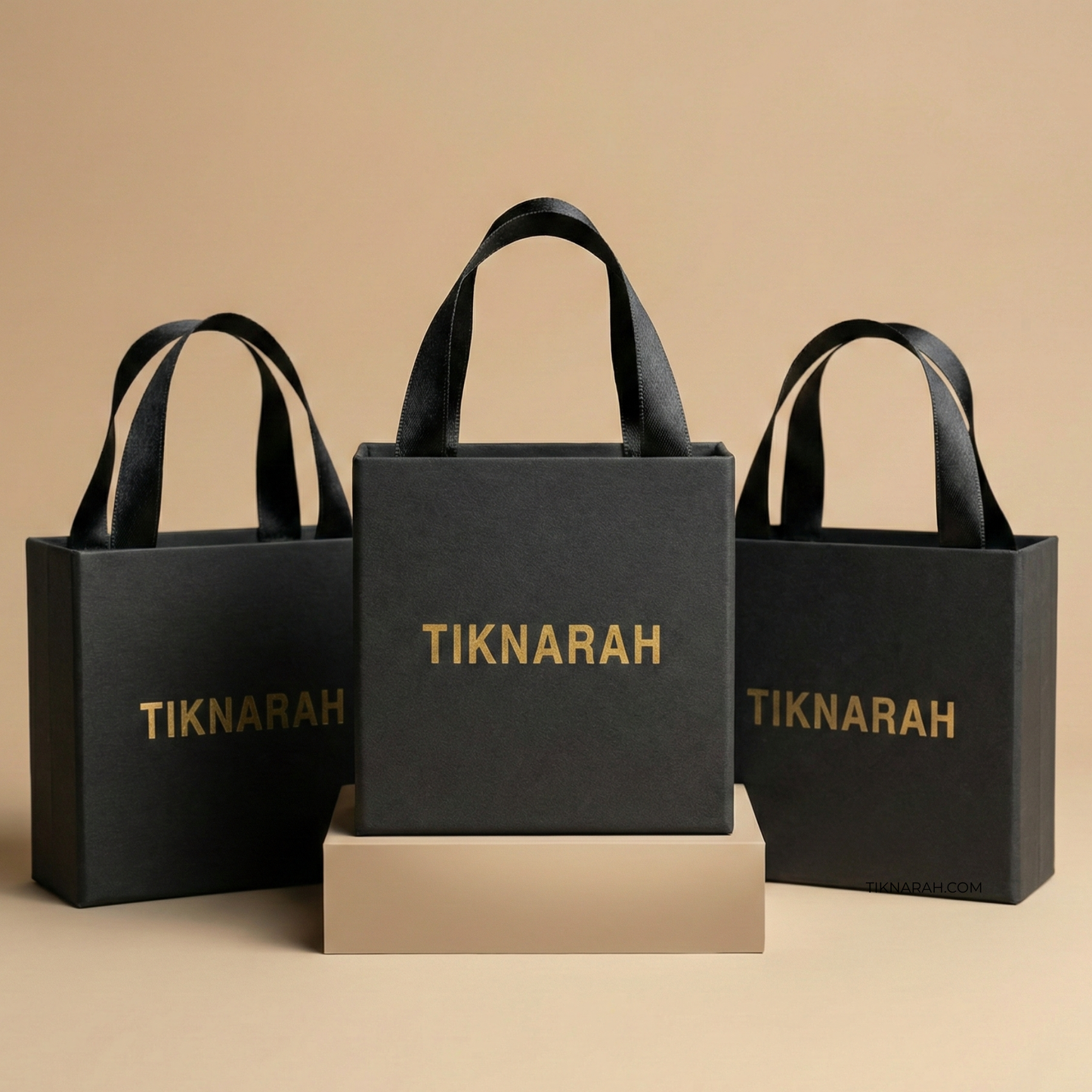 Three black bags with 'TIKNARAH' branding on a beige background