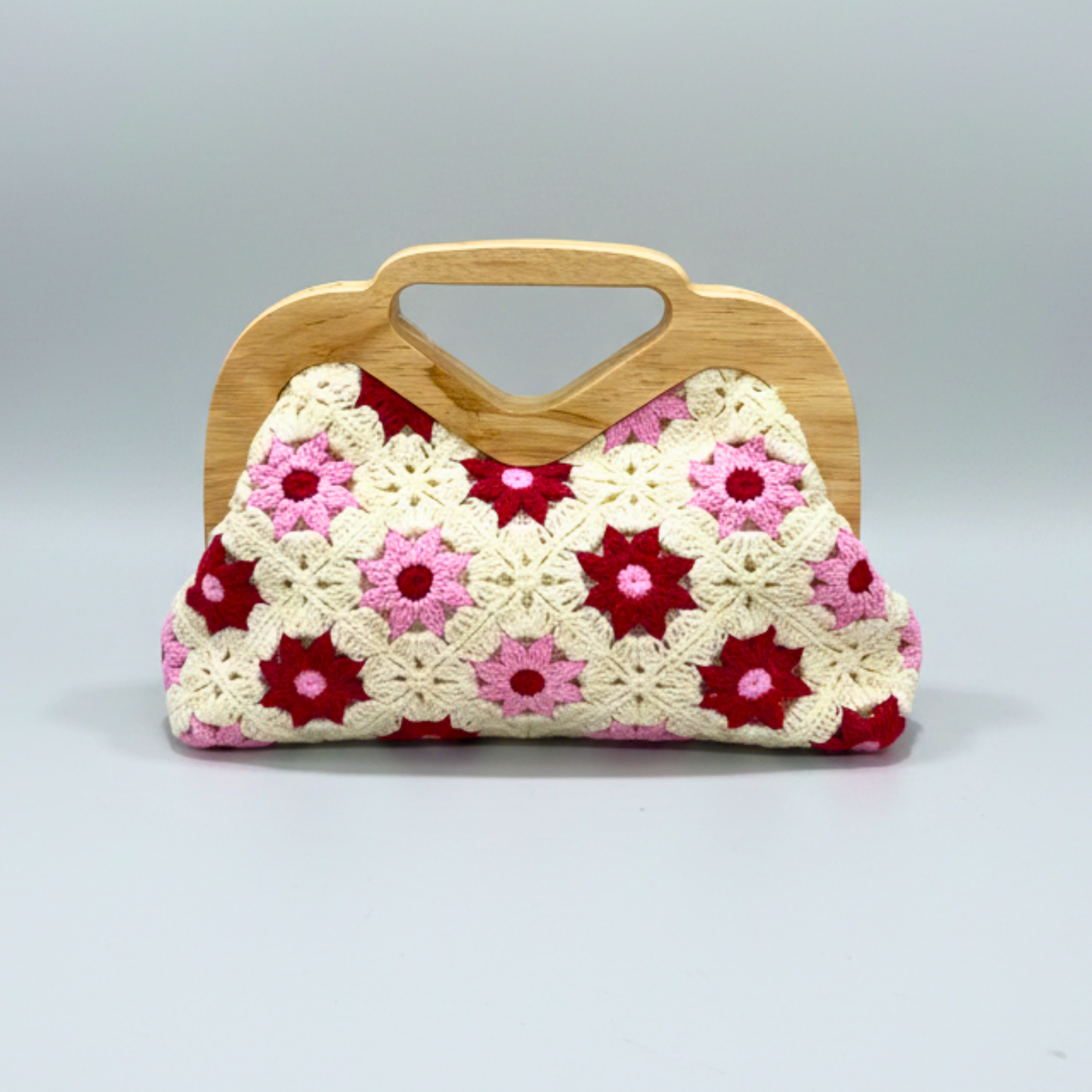 Handmade clutch bag with floral pattern and wooden handle on a gray Handmade crochet purse, floral knit handbag, wooden handle clutch, bohemian summer bag, granny square floral bag, sustainable fashion accessories, unique gift for her, crochet flower bag. background