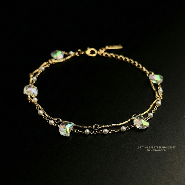 Gold bracelet with gemstones on a black background Double layer gold bracelet Iridescent crystal jewelry
Stainless steel pearl bracelet for women
Tarnish-free dainty gold jewelry
Celestial aesthetic accessories
Aurora borealis crystal bracelet
Waterproof gold chain jewelry
Hypoallergenic layered bracelet
Romantic gift jewelry for her
Minimalist gold and pearl stacking bracelet