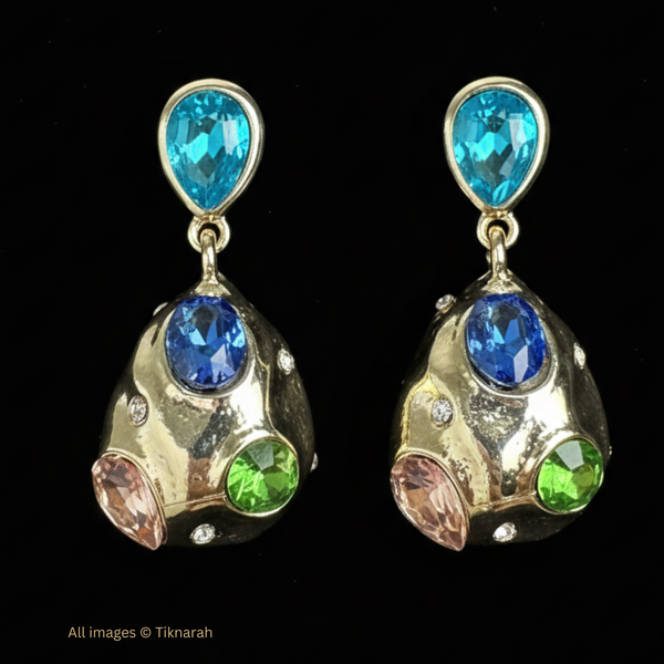 Gold earrings with blue and green gemstones on a black background Colorful drop earrings, multi-gemstone earrings, rainbow jewel dangles, organic gold earrings, statement crystal earrings, blue and green jewelry, bold gold studs, multicolored dangle earrings.