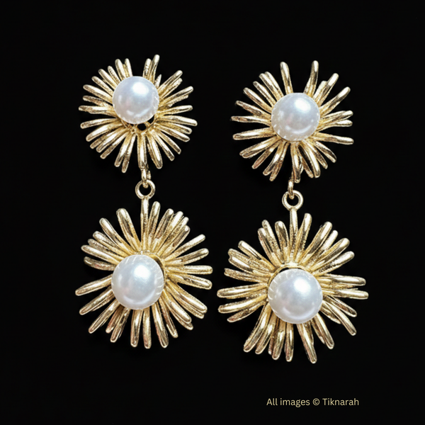 Gold earrings with pearl centers on a black background Sunburst pearl earrings, gold drop earrings, iridescent jewelry, floral statement earrings, celestial jewelry, wedding guest earrings, boho luxe jewelry, opal effect earrings.