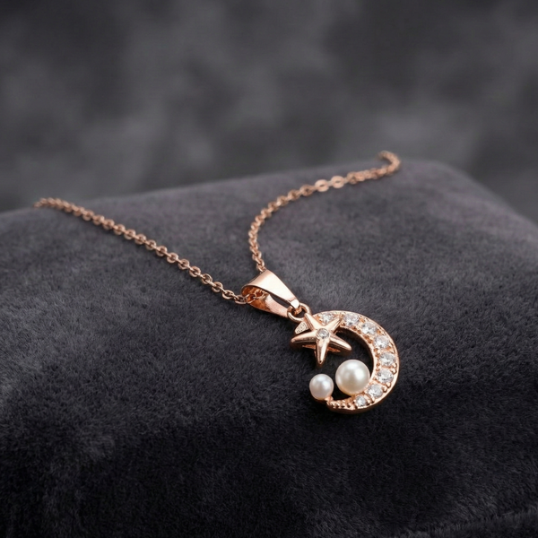 Rose gold necklace with a moon and star pendant on a dark surface Crescent moon necklace, rose gold celestial jewelry, moon and star pendant, pearl and crystal necklace, romantic jewelry gift, Tiknarah jewelry, women's fashion necklace, celestial charm necklace, rose gold pearl jewelry, night sky necklace.